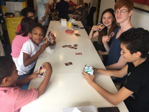 Young students playing Uno
