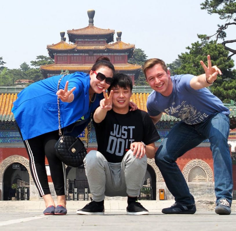 Three people posing in front of a temple in Chengde