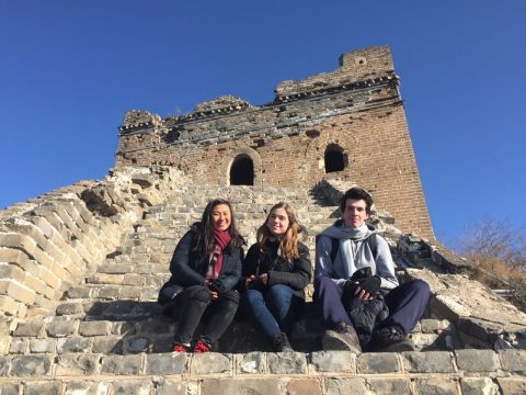 Three students sitting at the steps on the Great Wall of China